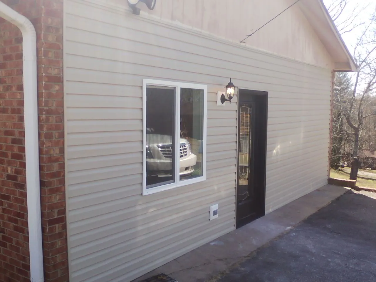 New vinyl siding and entry door on a room addition in San Bernardino