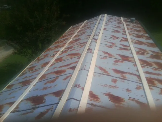 Rusted metal roof panels with new wood purlins before replacement — Storm Damage Roof Repair in San Bernardino by Roofing Brothers