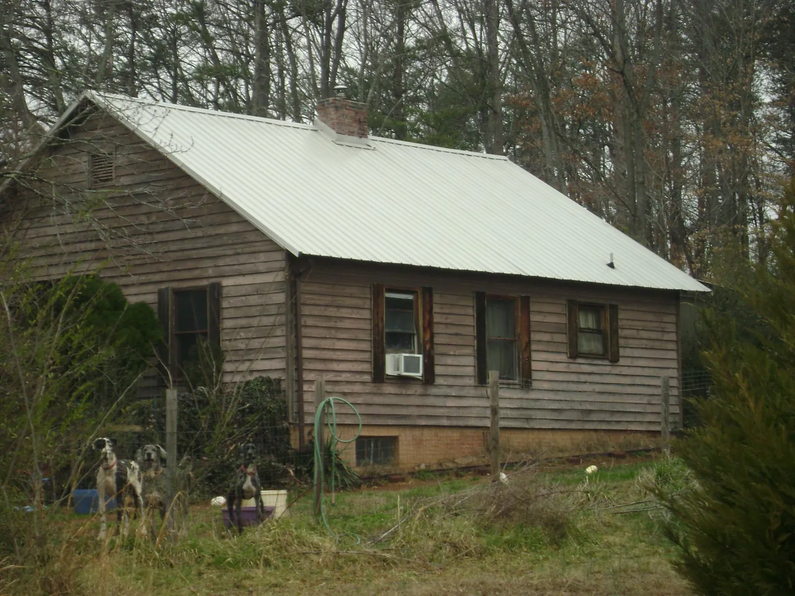 White metal roof on an old wood sided farmhouse, from a Asphalt Shingle Roof Repair job in San Bernardino